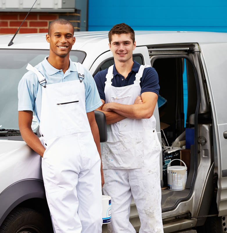 Two men in overalls standing infront of van containing painting equipment